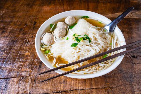 Bowl of shirataki noodle soup with meatballs