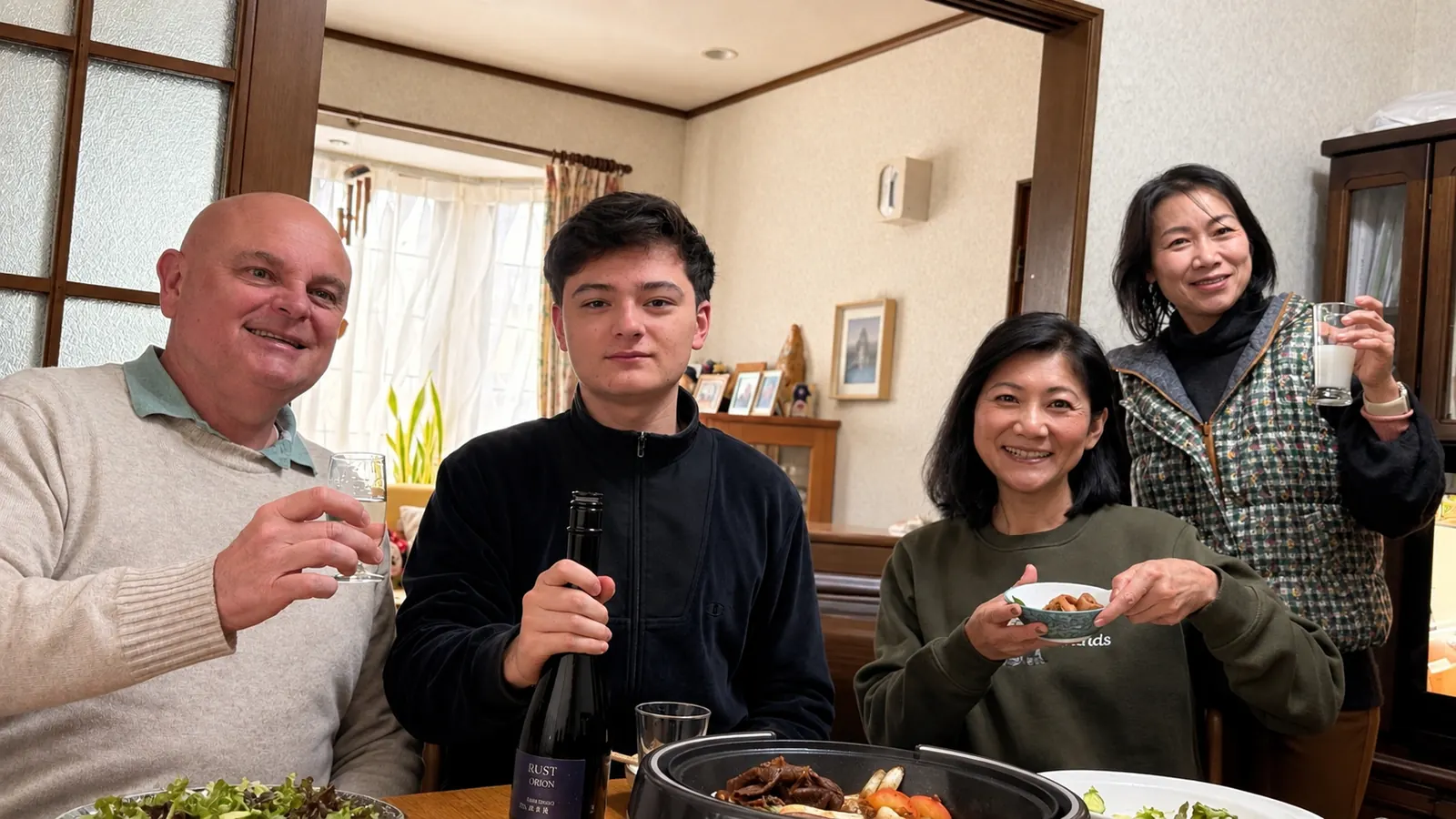 Dave and family raising a toast over sukiyaki at the family home in Japan