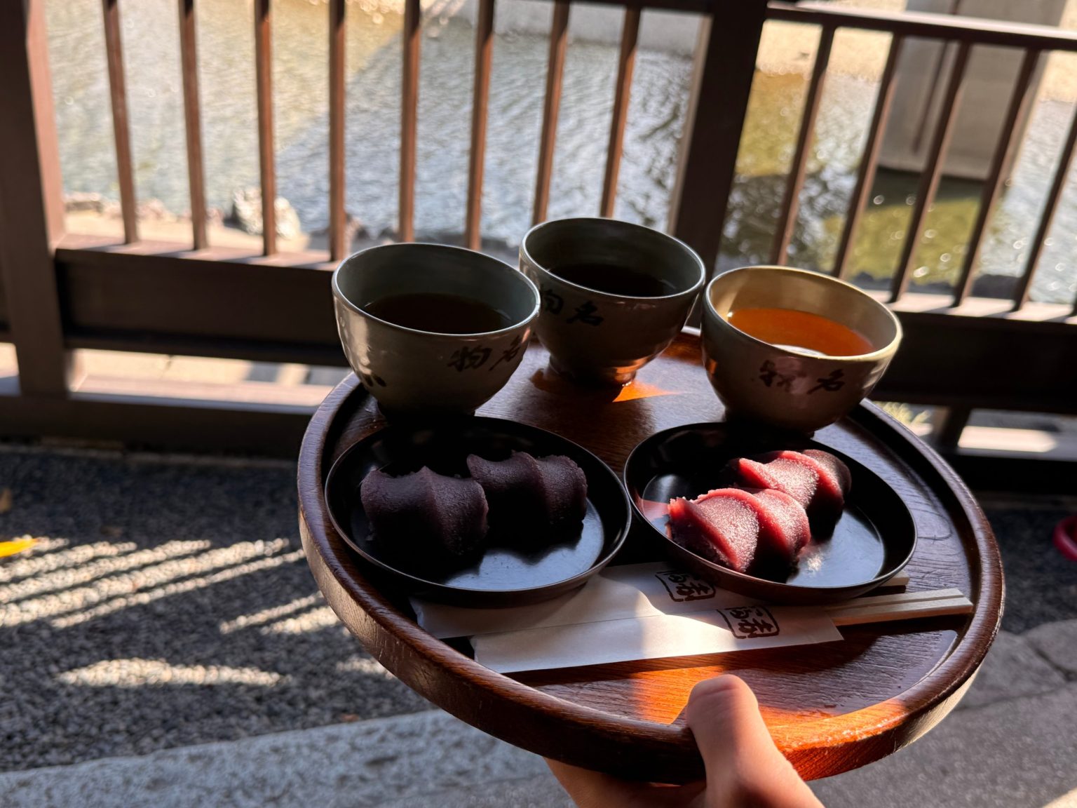 Tray of Akafuku mochi and tea held on the veranda above the Isuzu River