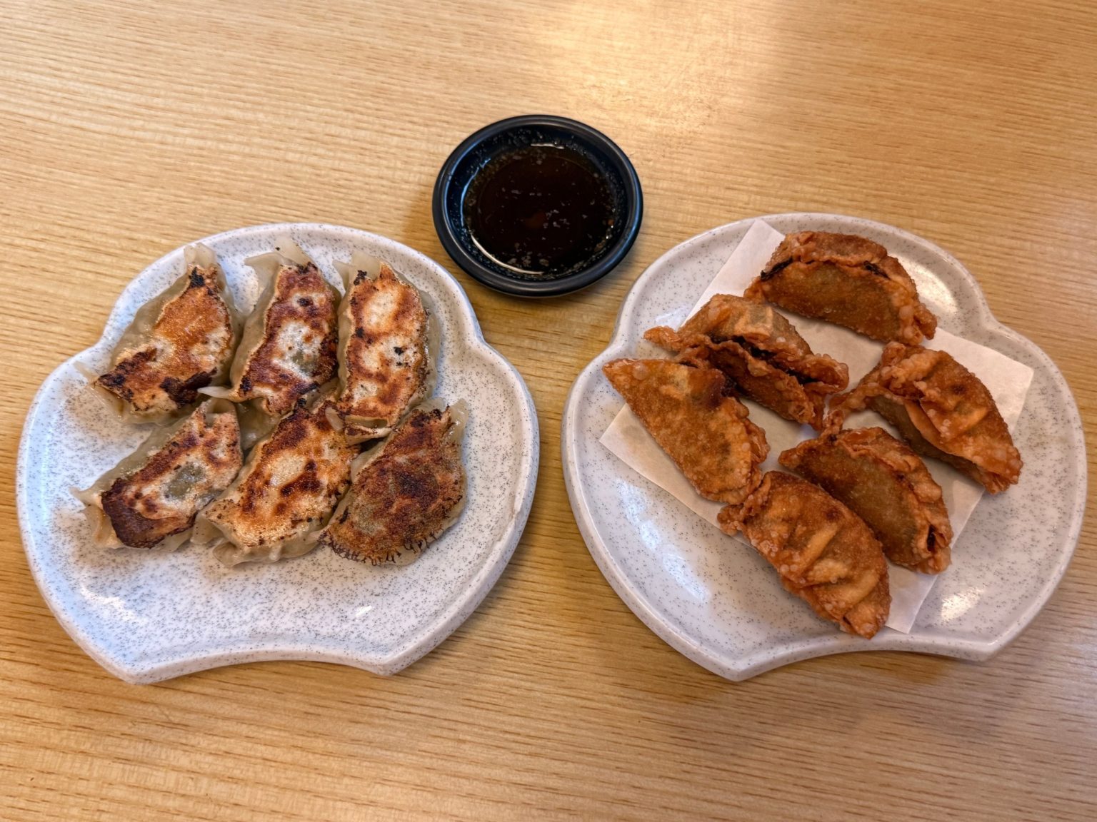 Pan-fried and deep-fried gyoza side by side with dipping sauce at Kawaichi, Kuwana