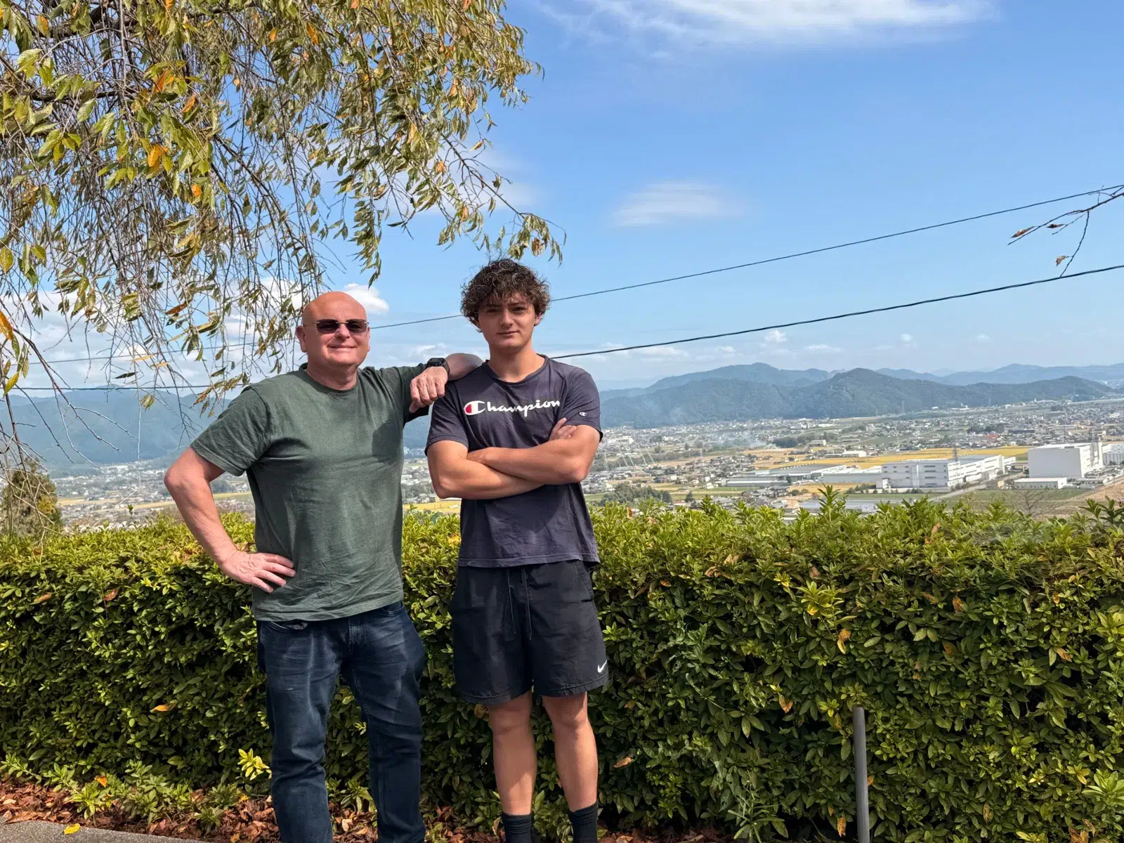 Dave and Kayne with the Nobi Plain, autumn rice fields and mountains behind them, Ikeda, Gifu